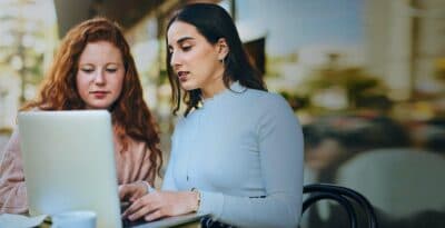 two ladies looking at computer