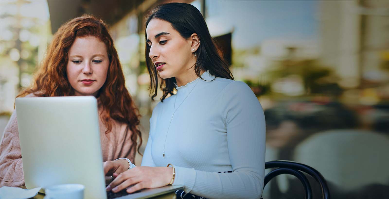 two ladies looking at computer